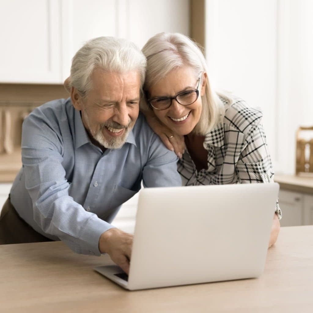 A couple reviewing information together on a laptop