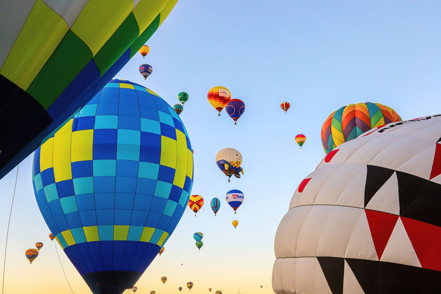 Colorful hot air balloons in the sky over Albuquerque at dawn