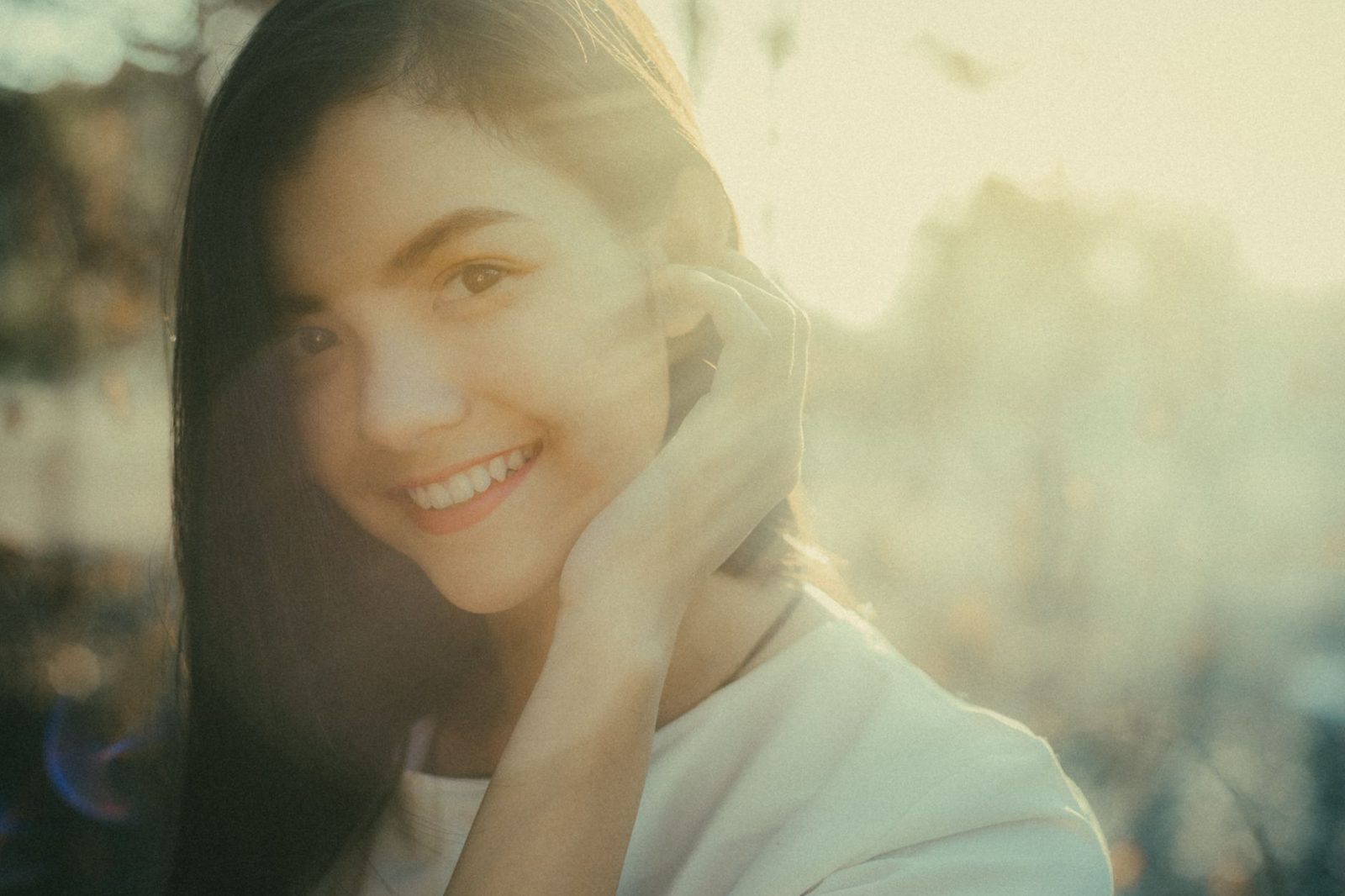 Smiling woman outdoors in soft sunlight